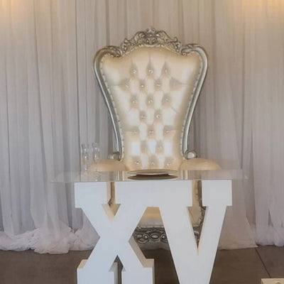 Large XV Foam Letter Table Base with a plate and two champagne glasses on top in front of a chair
